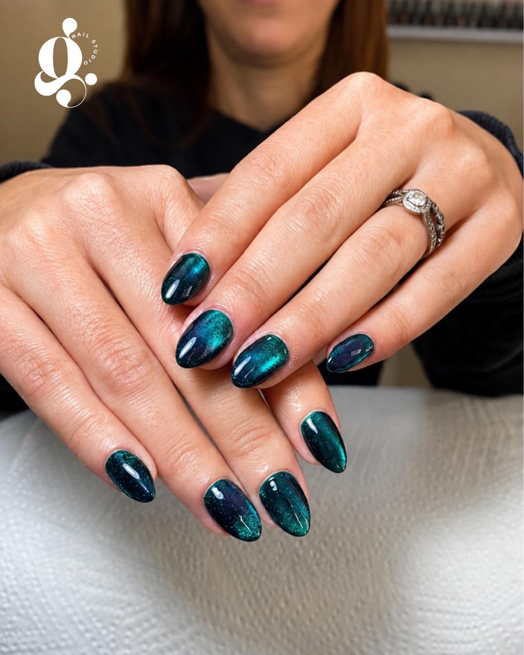 Teal cat-eye nails created at Glow Nail Studio